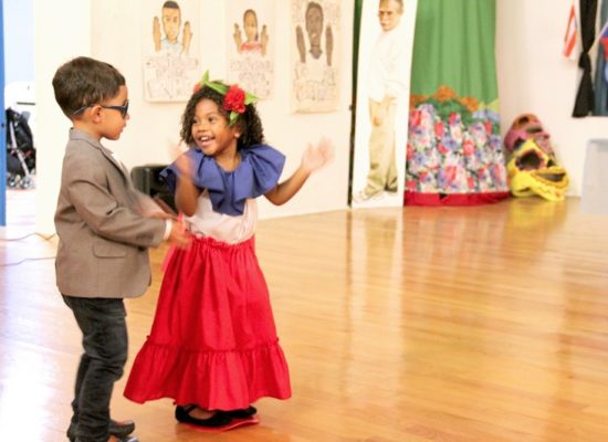 Boy and Girl dancing at Puerto Rican celebration event