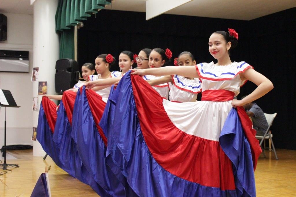 Girls wearing Dominican dresses at Dominican celebration event