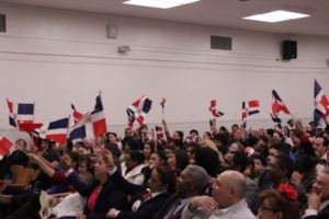 Attendees waving flags at Dominican celebration event
