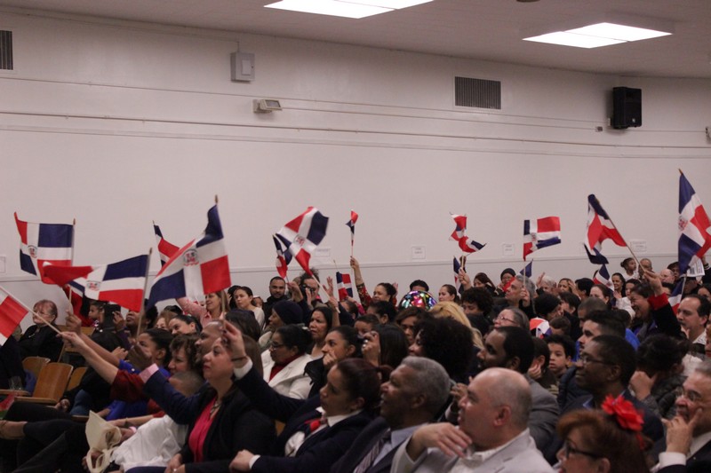 Attendees waving flags at Dominican celebration event
