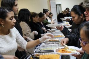 Volunteers serving food to attendees at a Los Sures event