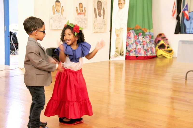 Boy and Girl dancing at Puerto Rican celebration event